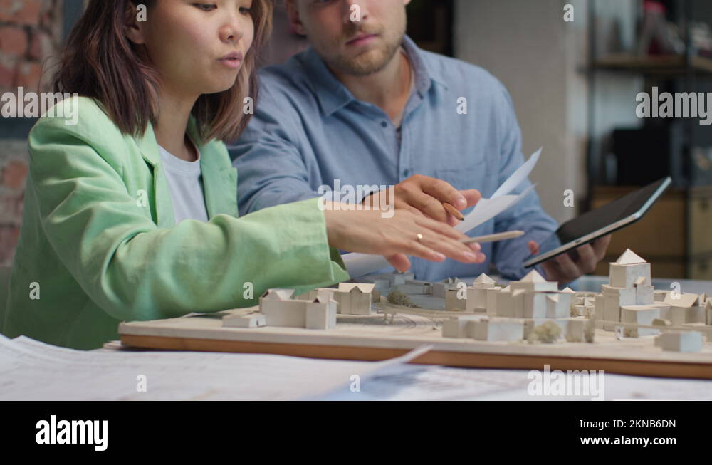 Architects and designers working on design of house blueprint in