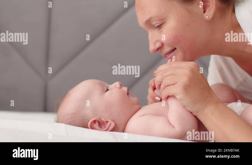 Mother Playing And Kissing Her Newborn Baby Mom Spends Time With Baby