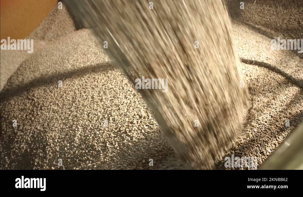 Clinkers Pouring Into Large Container At Cement Production Plant. close ...
