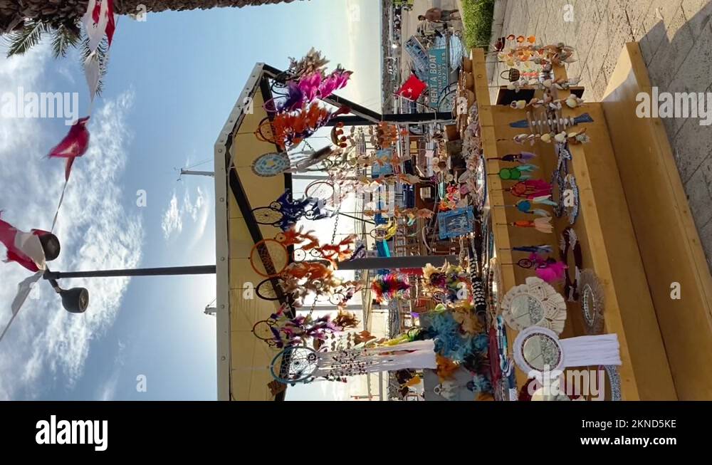 Vertical footage of Souvenir Dream catchers playing in the wind in a