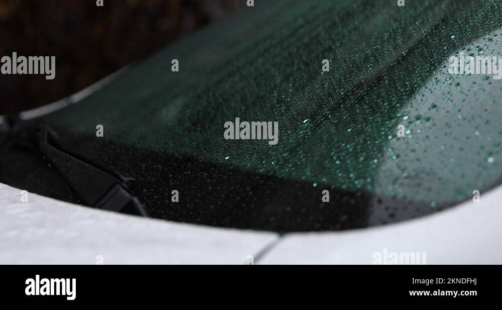 A video of a car's windshield wipers moving rain droplets out of the