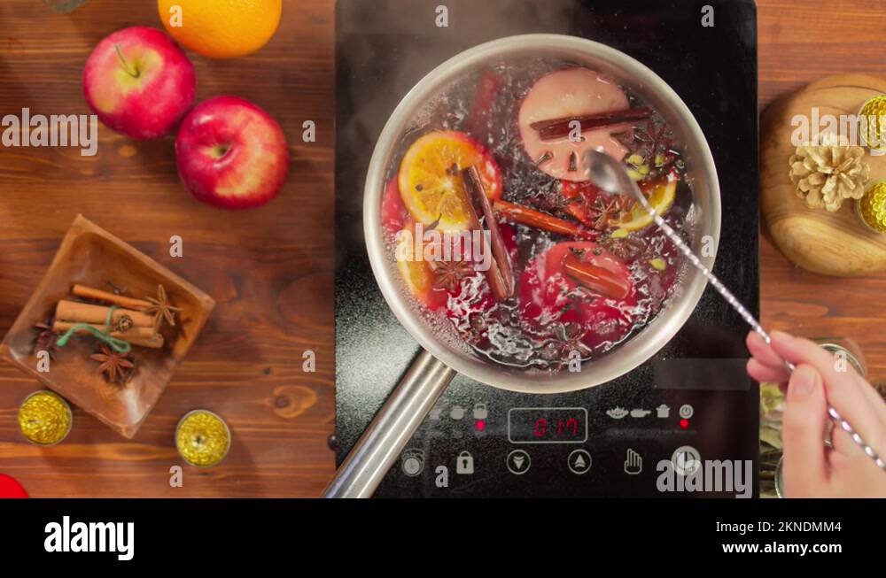 Cooking mulled wine top view, gluhwein recipe. Boiling red hot wine