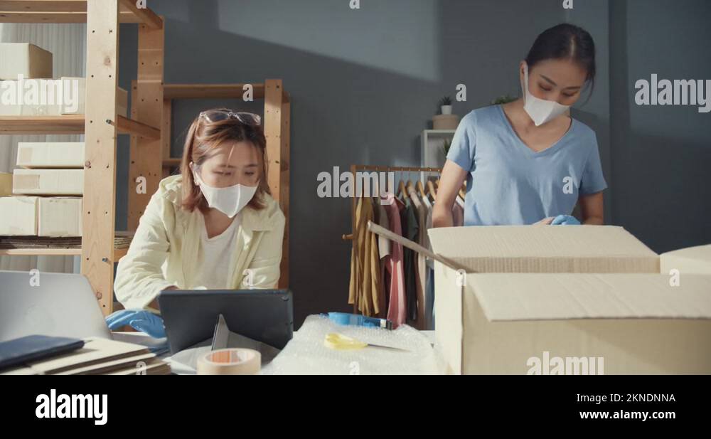 Lady wear mask check stock inventory system prepare packing order Stock ...