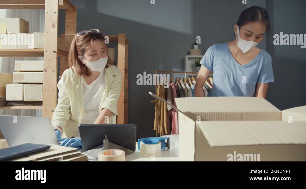 Lady wear mask check stock inventory system prepare packing order Stock ...