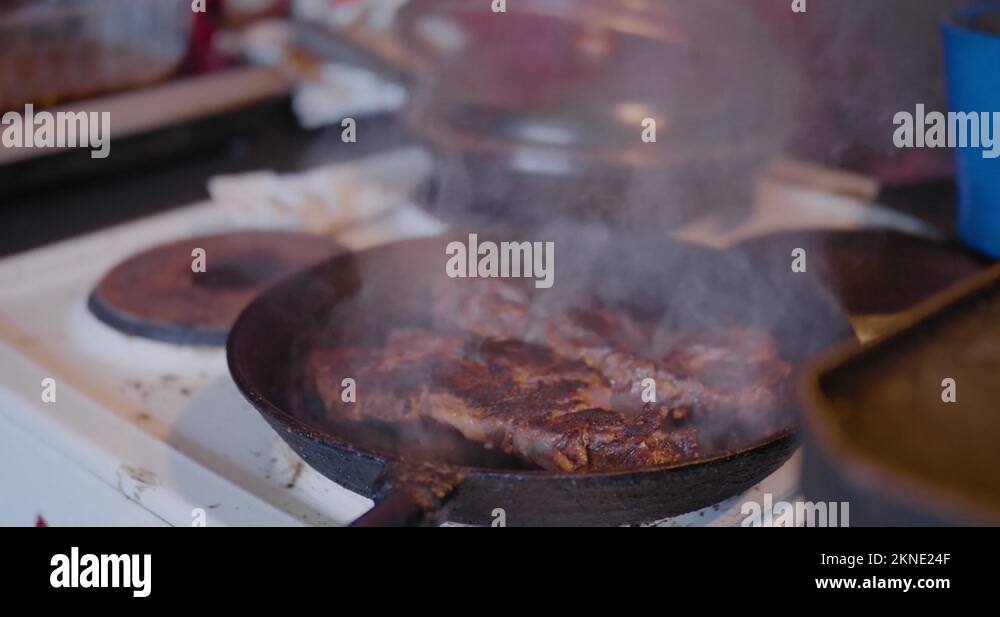 Meat Smoking in Cast Iron Skillet in an Old Countryside Kitchen