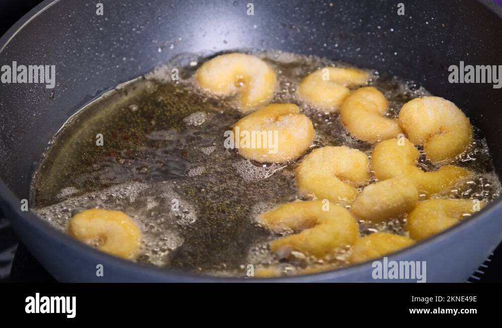 Cooking Batter Fried Shrimp with food oil in pan on electric stove