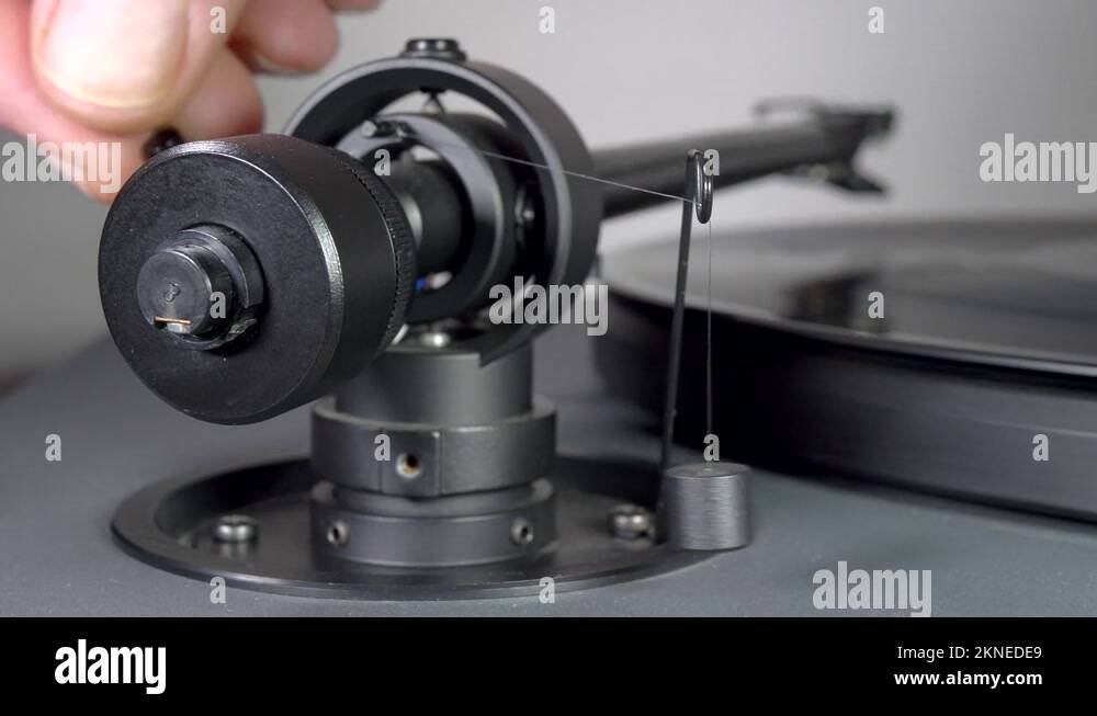 Rear of a record turntable tonearm with a suspended balancing weight