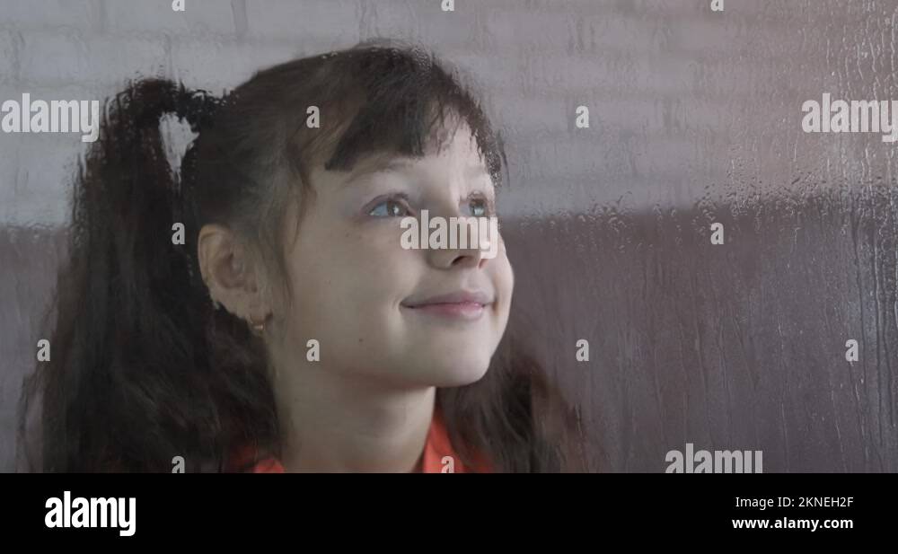  Smiling face by rainy window Stock Video Footage - Alamy