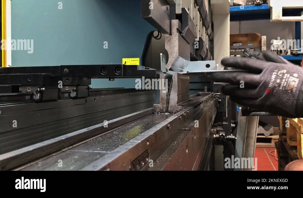 Bending sheet metal on a hydraulic machine at the factory. Bend tools