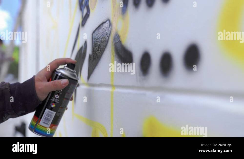 Graffiti Spray can in front of a white wall. Hand holding a spray can ...