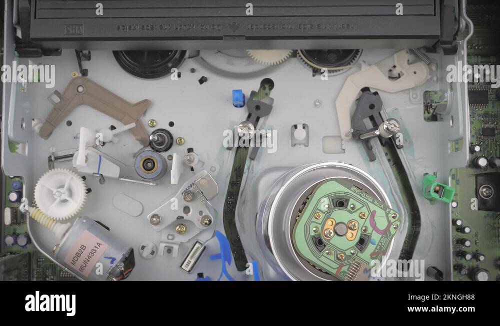 Closeup shot showing inside of a vcr while it ejects a vhs cassette