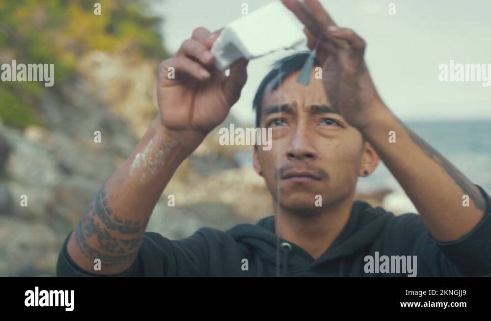 Young Nepali man setting up fishing lure recycling polystyrene as float