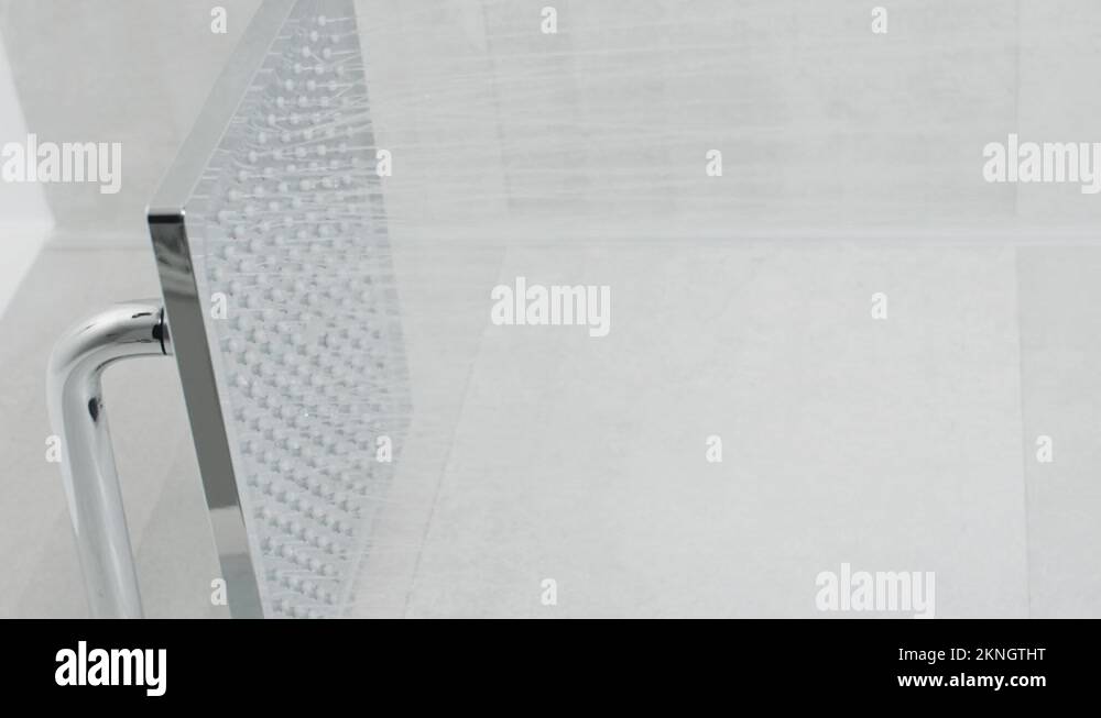 Vertical turning on shower head in modern bathroom, water flow, falling