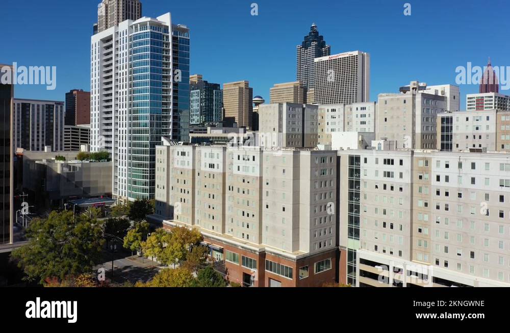 Rising aerial of apartment complex and high rises in downtown Atlanta