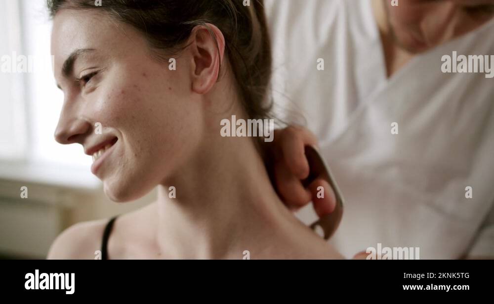 Fascia release soft tissue treatment on her neck with stainless steel