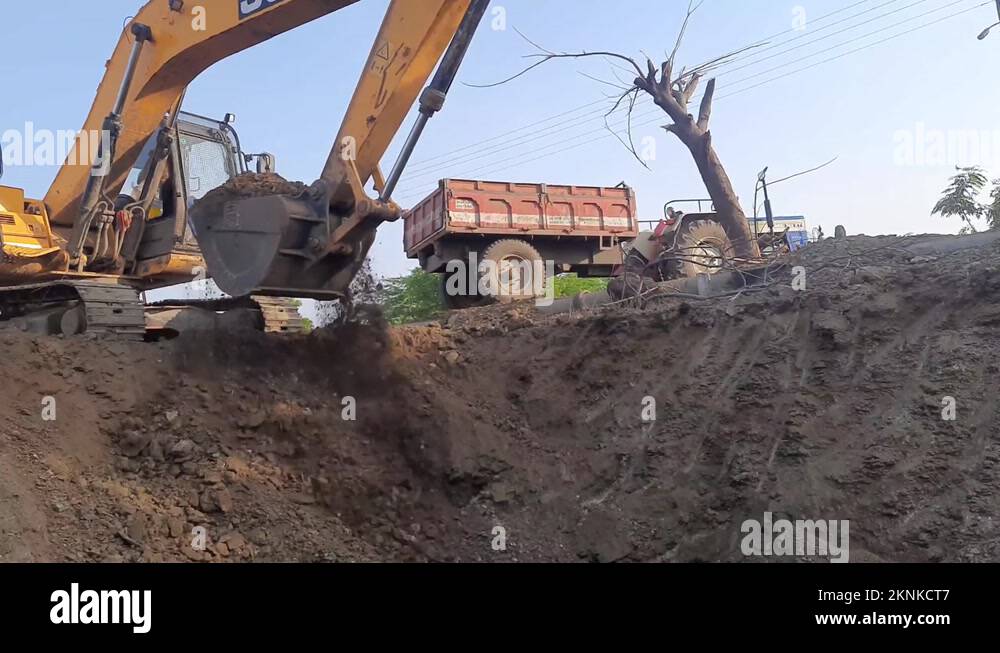 An excavator and a tractor dig and load the construction soil. Excavator Stock Video Footage Alamy