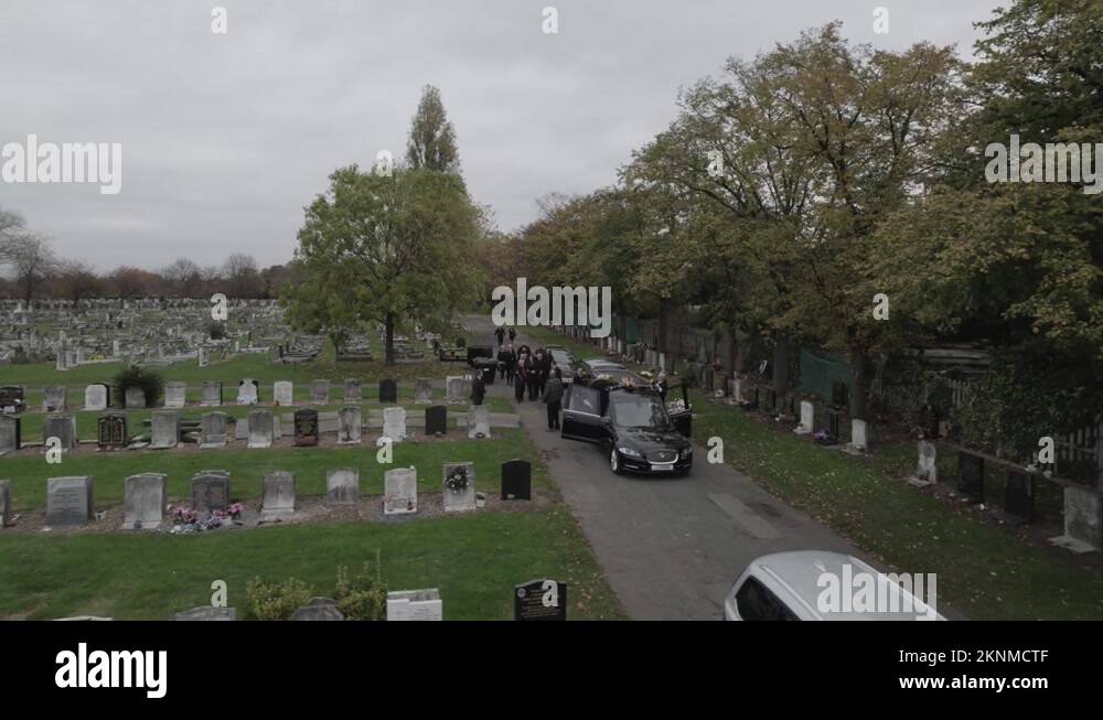 Funeral car and people in cemetery during burial Stock Video Footage