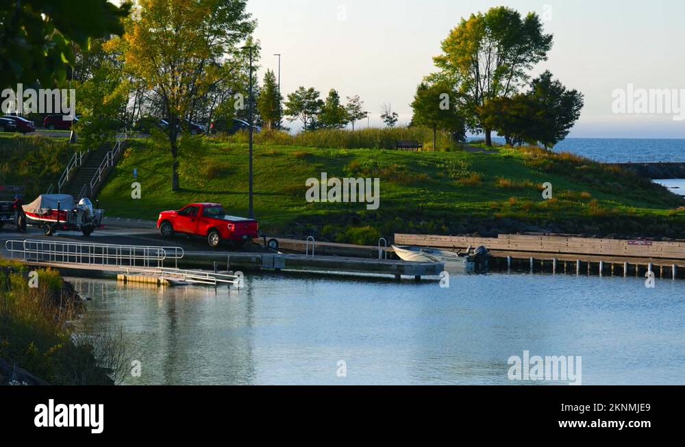 TWO HARBORS, MN 29 SEP 2021 Red pickup backs trailer down a boat