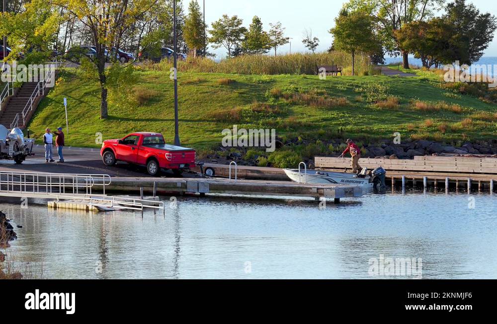 TWO HARBORS, MN 29 SEP 2021 Fishing boat is pulled onto trailer at ramp Stock Video Footage