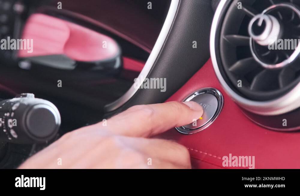 Close up shot hand of a man pushing start stop button to ignition car