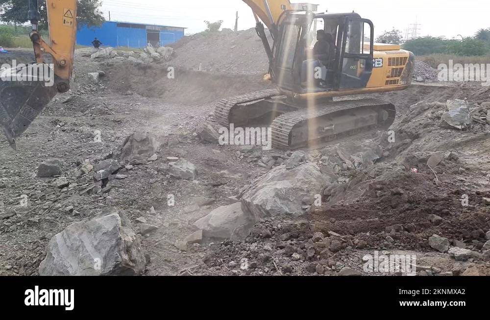 Excavator removing rock and soil from the construction site Stock Video ...