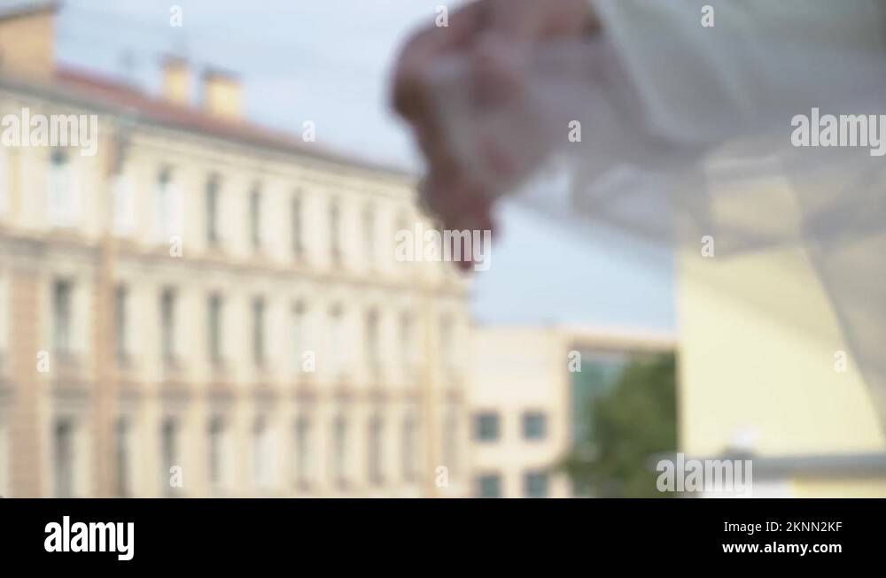 Bride in a white wedding dress with sleeves throws and flutters a veil