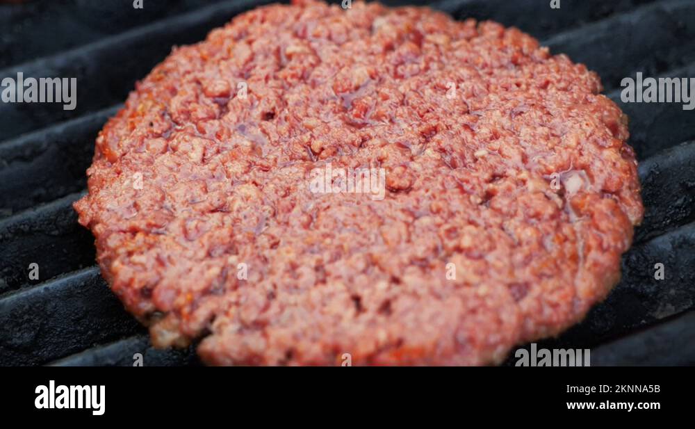 Barbecuing plant based Impossible Burger patties on electric grill close Stock Video Footage Alamy
