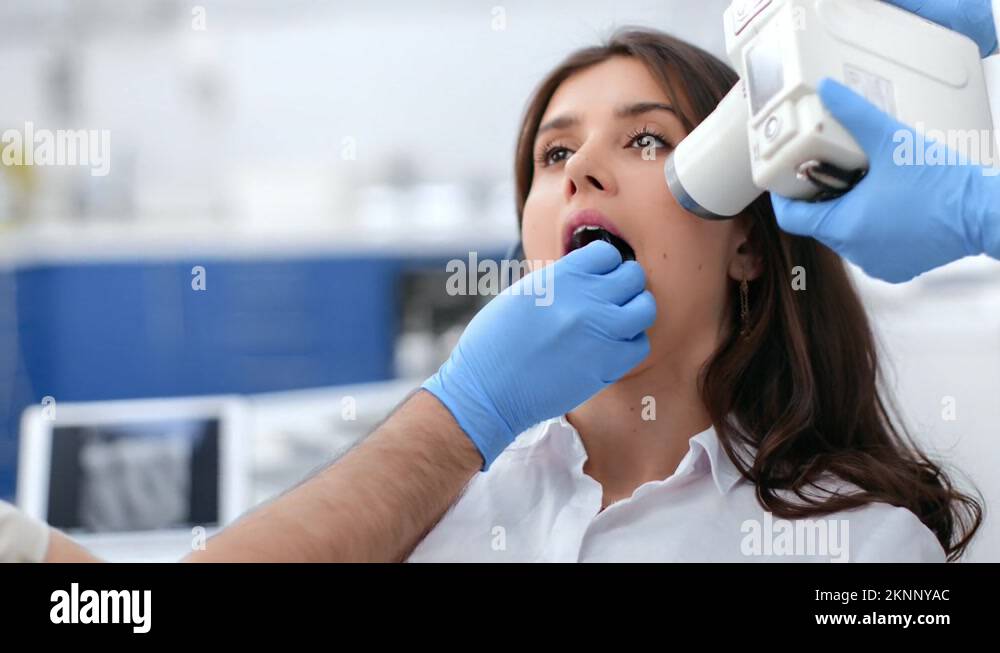 Male dentist x ray image of female patient oral cavity tooth checkup