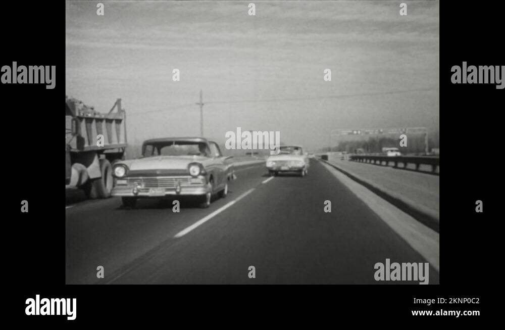 1950s: Tracking shot, cars driving on highway, car changes lanes Stock ...