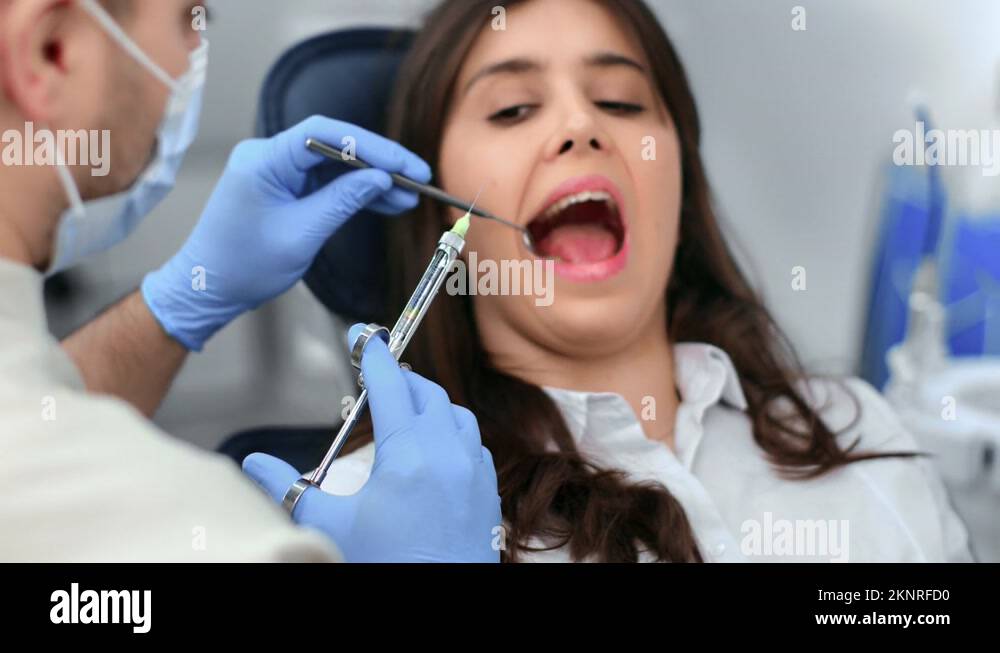 Female patient with toothache open mouth anesthesia injection teeth