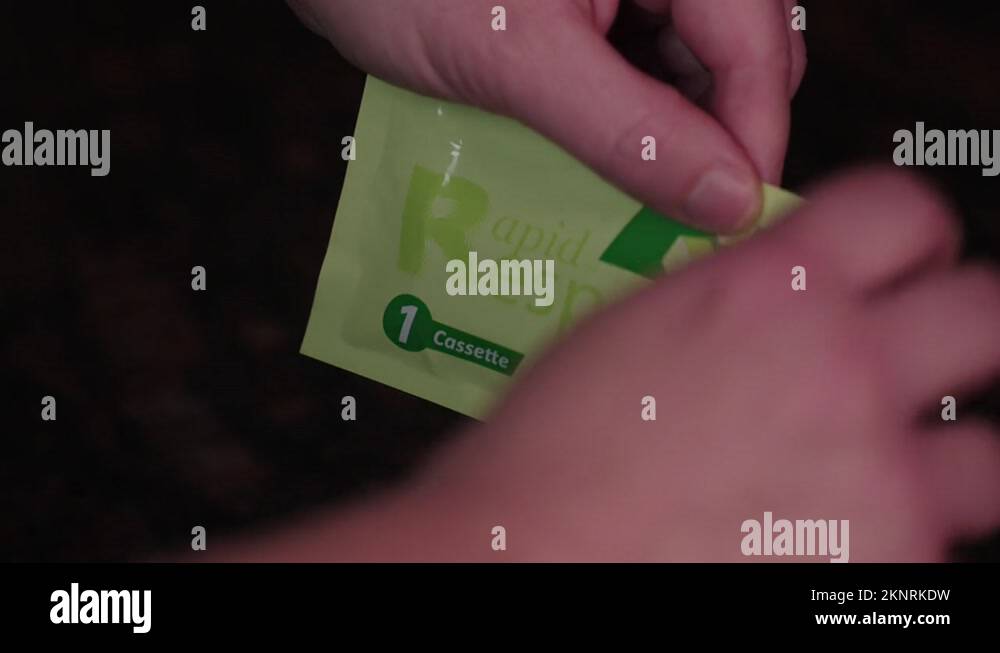 Hands tearing open a COVID19 antigen Rapid Response test Stock Video