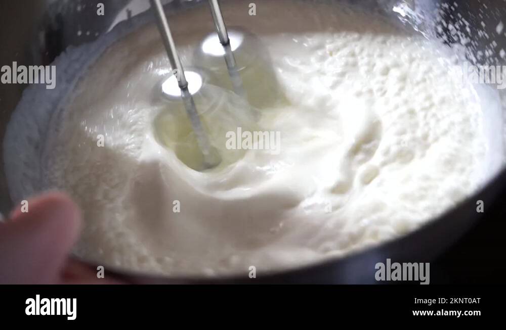 Whipping cream with an electric mixer Stock Video Footage Alamy