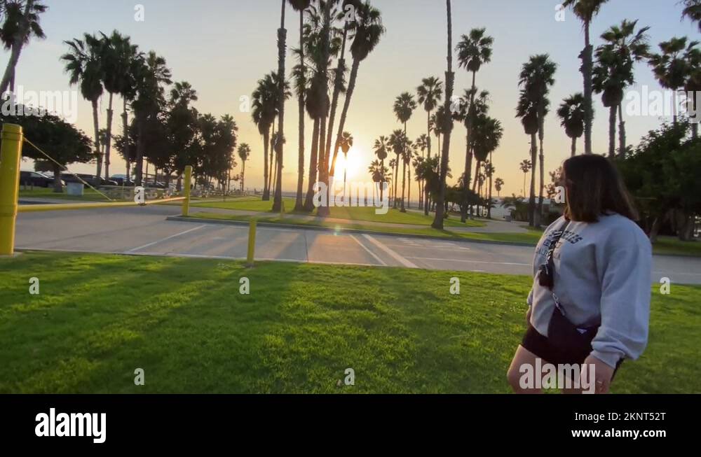 Girl walking at Santa Monica Venice beach during golden hour with Stock