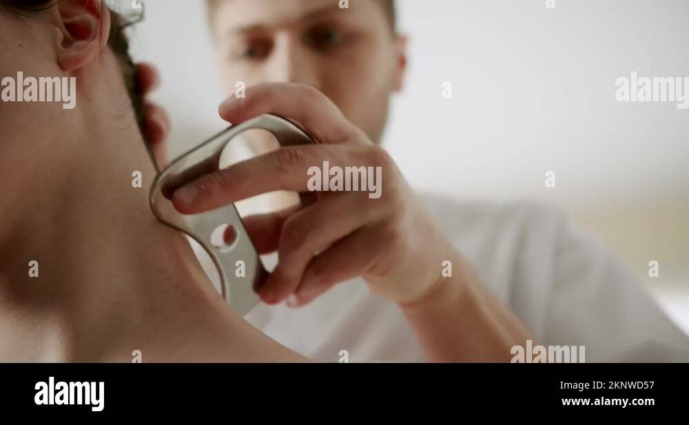 Fascia release soft tissue treatment on her neck with stainless steel