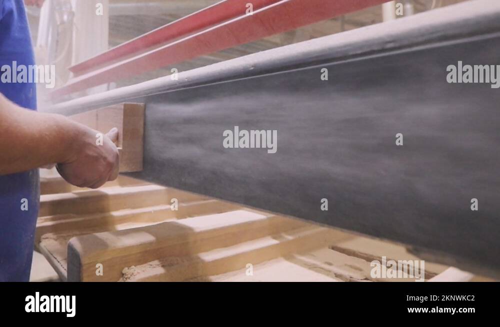 Furniture manufacturing process. Wood furniture sanding. A worker is