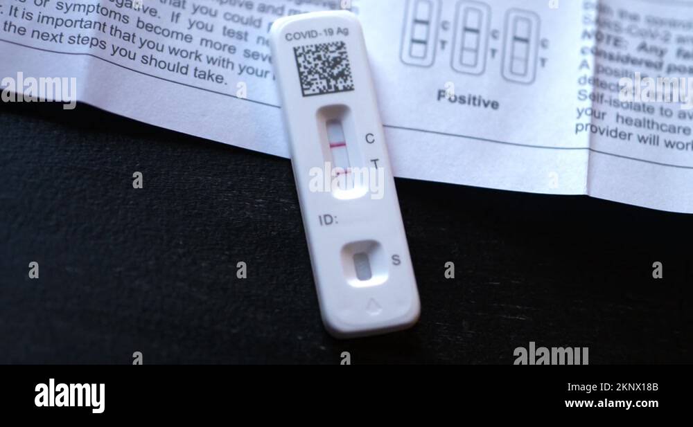 Covid 19 positive at home antigen test kit on black table with