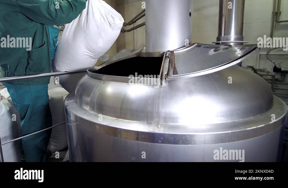 Beer ProductionPouring Malt Grains Into A Large Grinding Tank At The