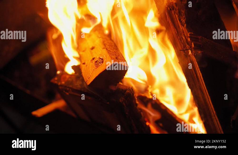 Fire burns at night. Fire hazard. Firewood is burning. Closeup Stock