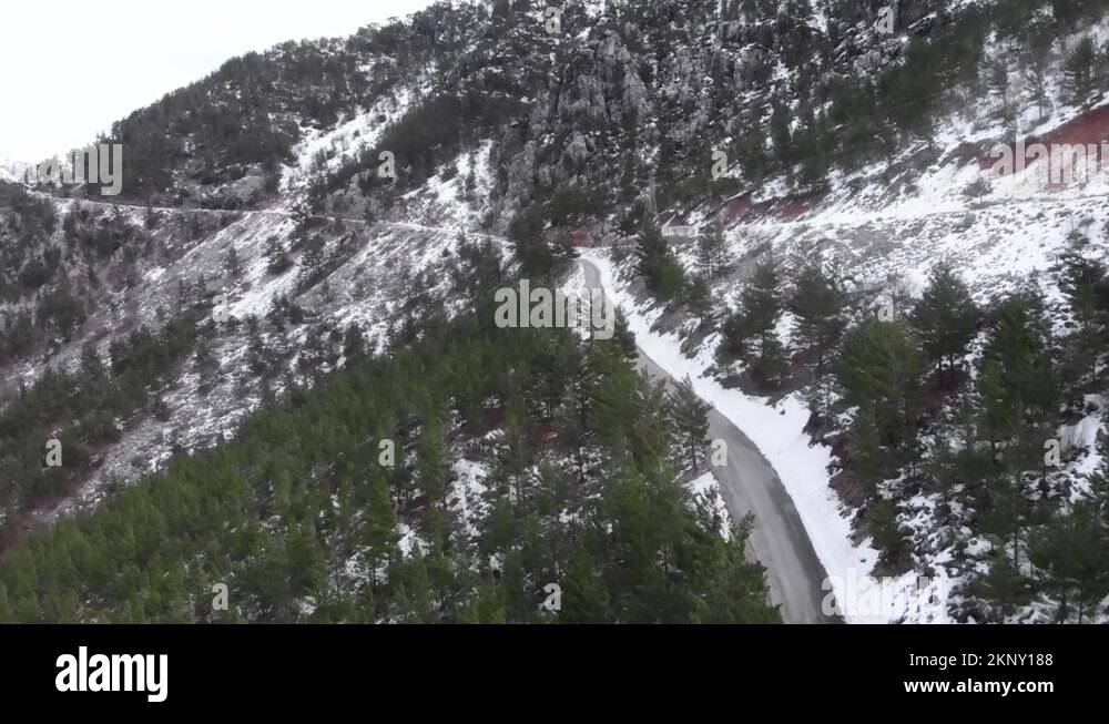 Snowy mountain switchbacks. Mountain peaks in snow with empty car road ...