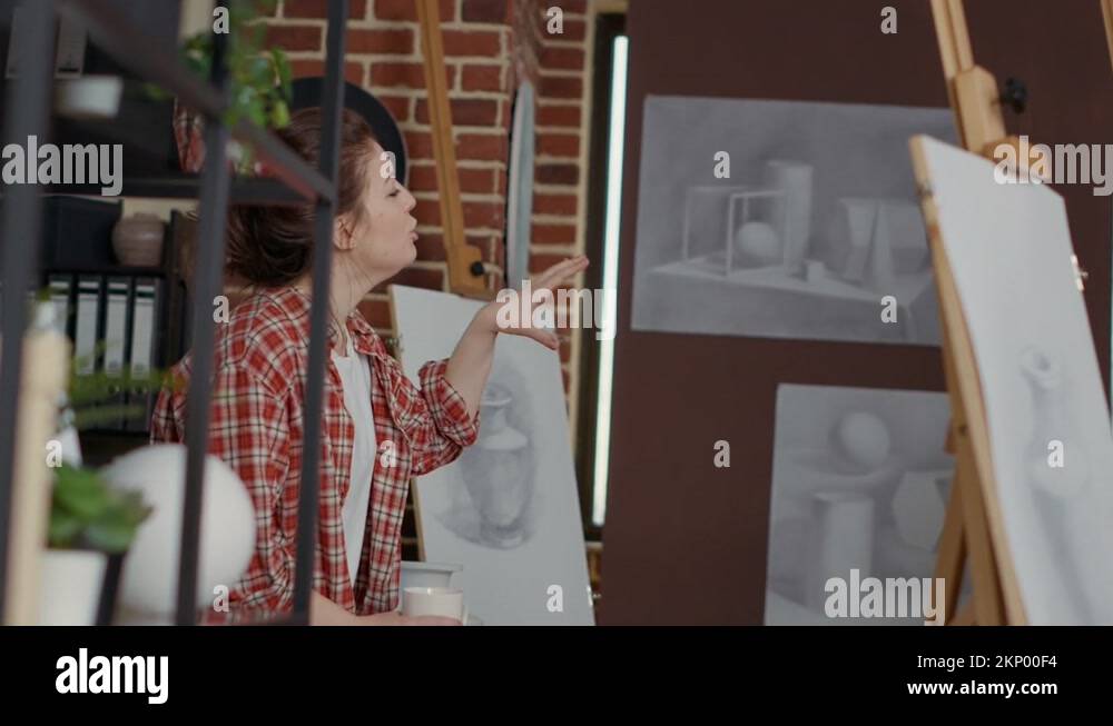 Female artist using vase model to explain drawing technique Stock Video