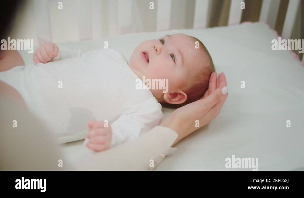 Concept of childhood parenting cute baby girl laying down on the baby
