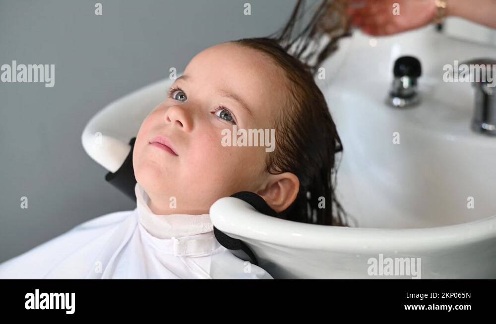 cute girl child getting a haircut in the salon wash their hair Stock Video Footage Alamy