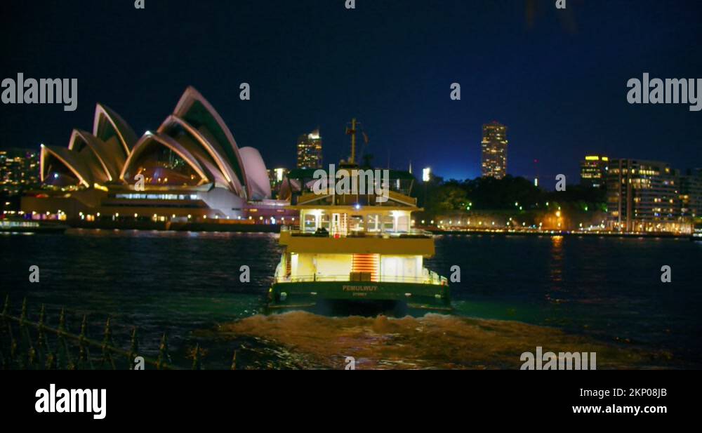 Ferry Boat Sailing At Port Jackson Near Sydney Opera House During Night