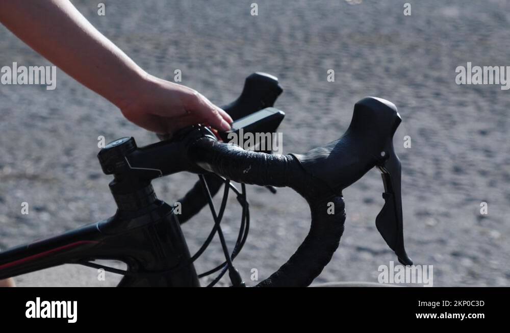 Bicycle road maps Stock Videos - Cyclist Using Bicycle Computer On Handlebar Of Road Bike Person Turning On 2kp0c3d 