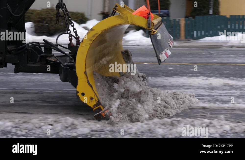 Big truck with plow and salter clearing street of snow. Toronto, Canada