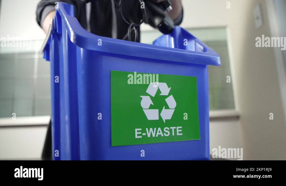 Recycling Old Electronic Devices In an E Waste Recycling Bin at Home