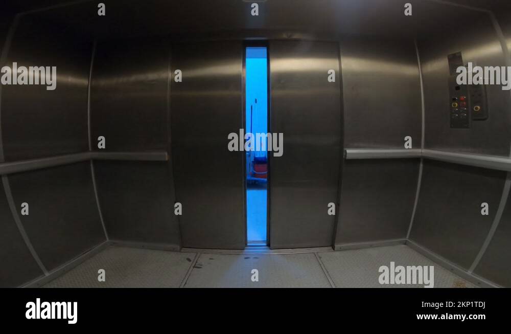 elevator doors open reveal sanitation area, cleaner carts Stock Video