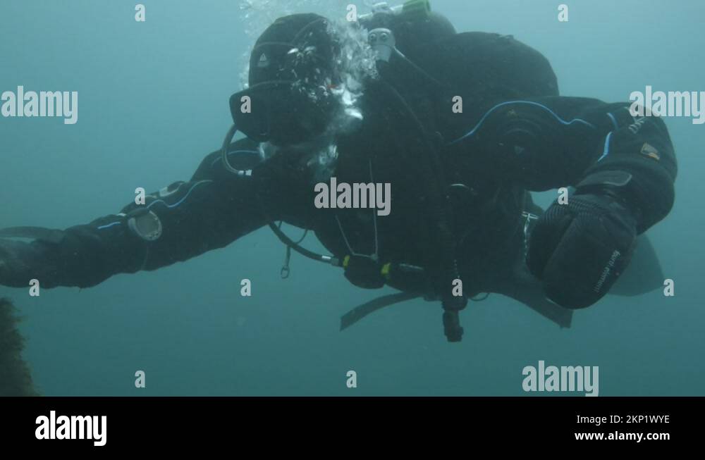 Scuba diver makes safety stop on anchor line on ascent to surface Stock