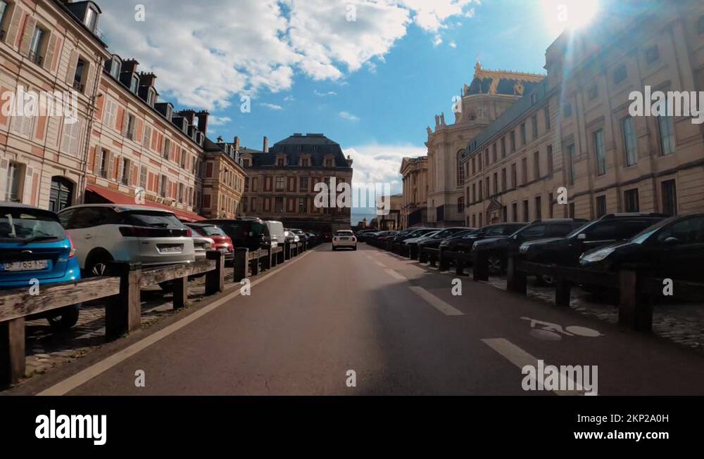 Pov car driving towards Palace of Versailles Paris streets architecture
