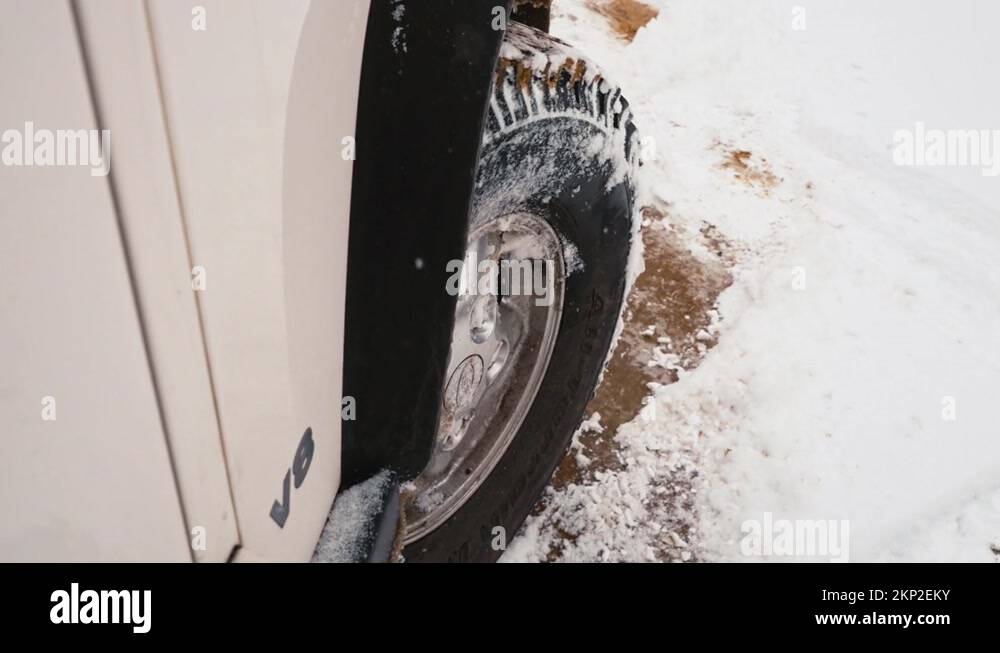 SUV Wheel Backing Up Sliding On Snow And Turning To Take Off Driving